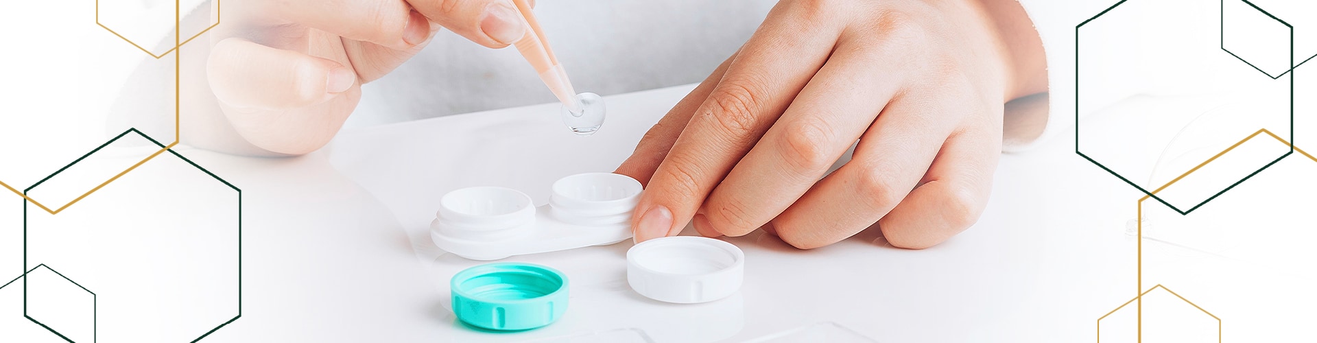 close up of hands holding contact lenses