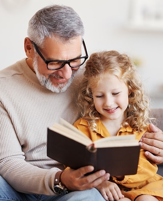 man and young girl reading